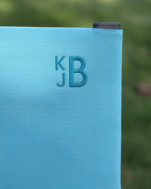 Monogram embroidery stitched on a Common Tiger chair cover